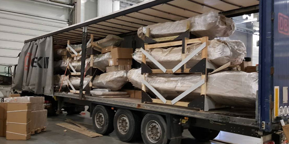 Truck filled with rigid inflatable boats (RIBs) ready for transport.